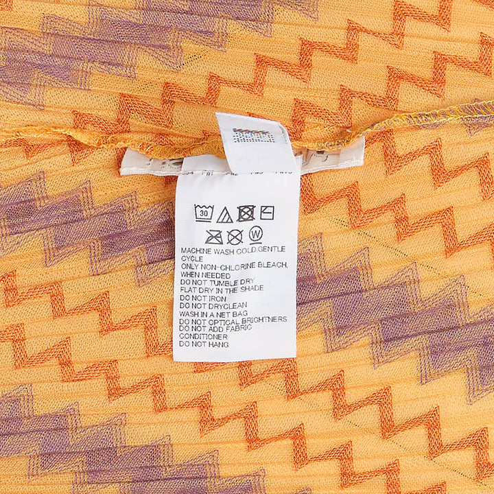 Pleats Please Issey Miyake Cotton Zigzag Pleated Shirt — back view, flutter sleeves, vertical zigzag stripe pattern in gold, purple and orange