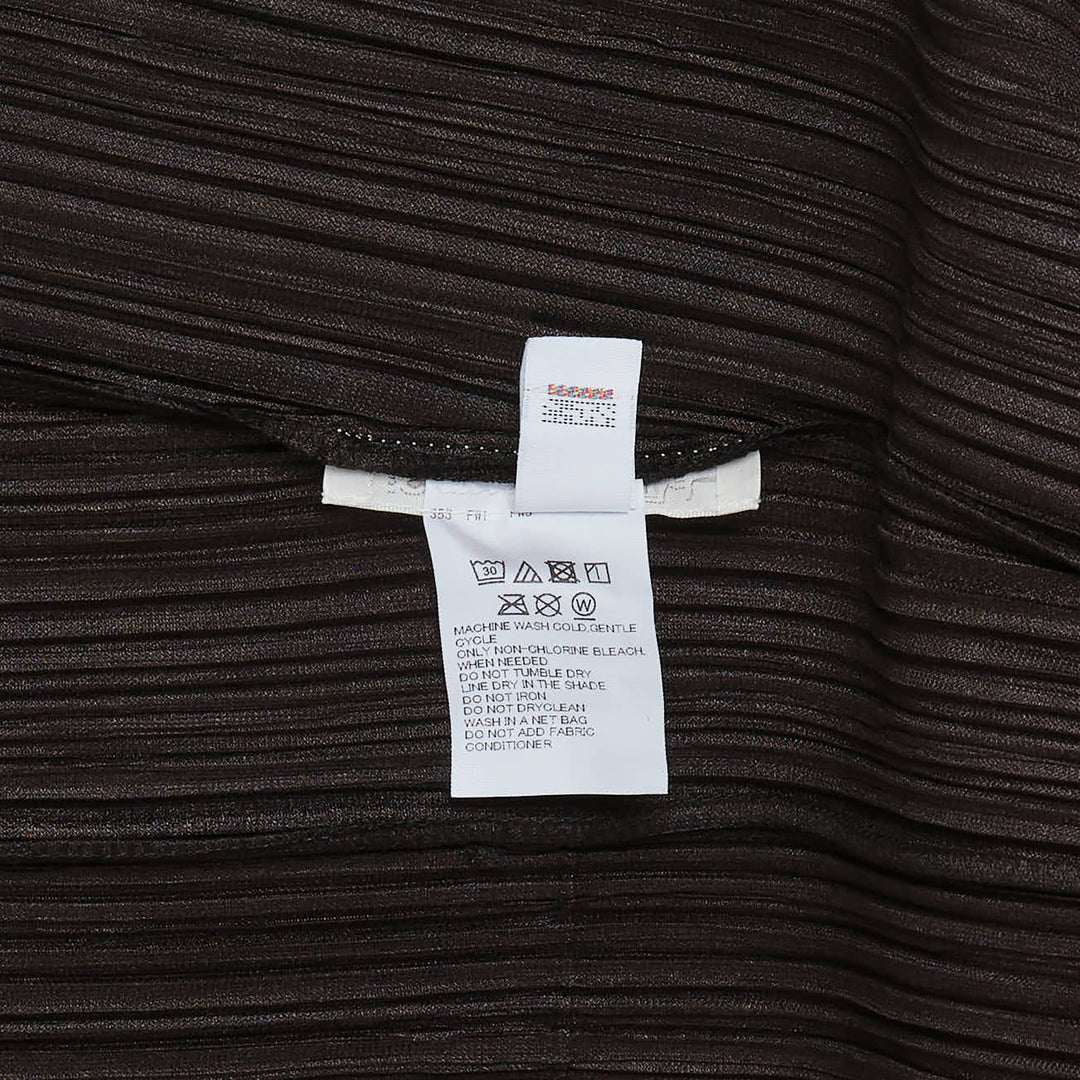 Pleats Please Issey Miyake Mellow Pleats Cardigan in black — rear view showing open-front silhouette with long sleeves and micro-pleated fabric