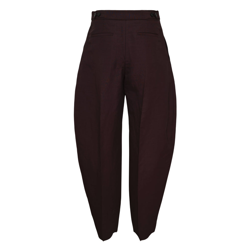 Alaïa Viscose Blend Tailored Pants in deep burgundy with high waist, front pleats, and balloon silhouette tapering at the hem