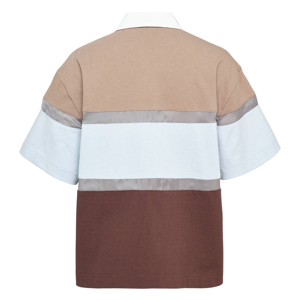sacai color block short sleeve shirt with forest green, dusty mauve, and black panels separated by horizontal satin ribbon trim, featuring a concealed button placket and satin-trimmed point collar