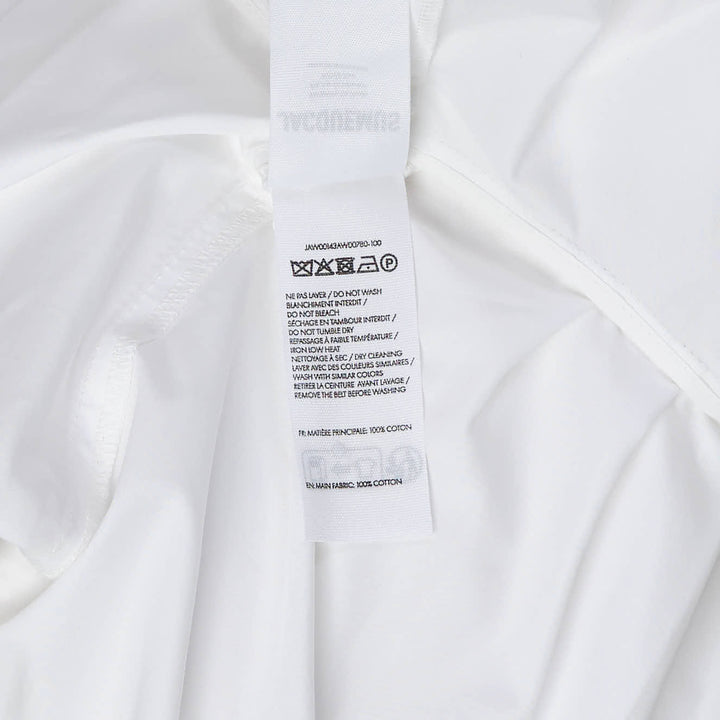 Jacquemus Cabana Woven Blouson in white with stand collar, wide long sleeves, and a self-tie belt, displayed flat on a white background