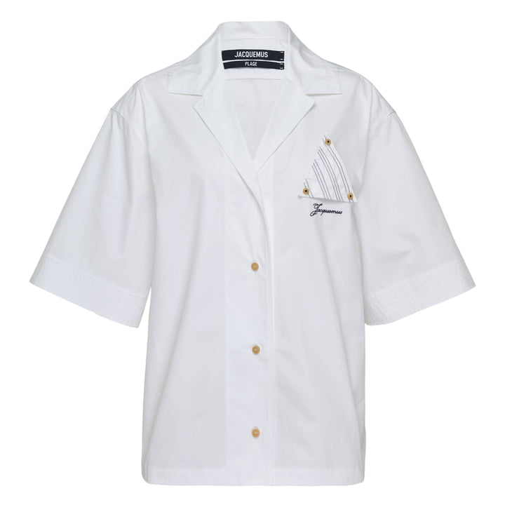 Jacquemus La Chemise Marin white woven short-sleeve camp collar shirt with gold buttons and embroidered logo chest pocket from the Plage collection