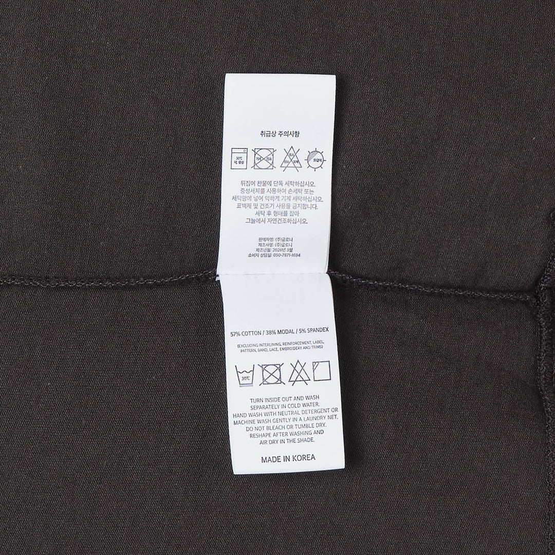 Glowny Los Angeles Apple Graphic Tee in washed charcoal black with pink apple illustration, cursive script lettering and silver star accents on the chest