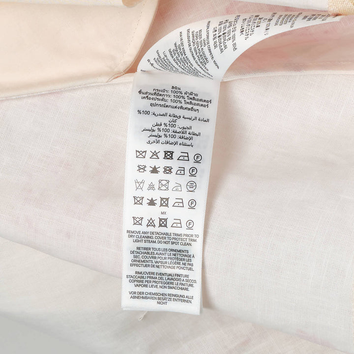 Zimmermann Roselight Picnic Mini Dress in cream with pink rose floral print, V-neckline, spaghetti straps, and flared A-line skirt with lace hem trim