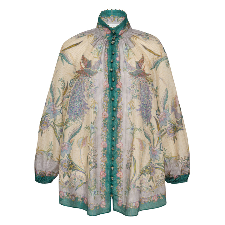 Zimmermann Indra Billow Blouse in cream with peacock and floral print, teal contrast placket with jewelled buttons, ruffled embellished collar, and billowy long sleeves with teal cuff trim