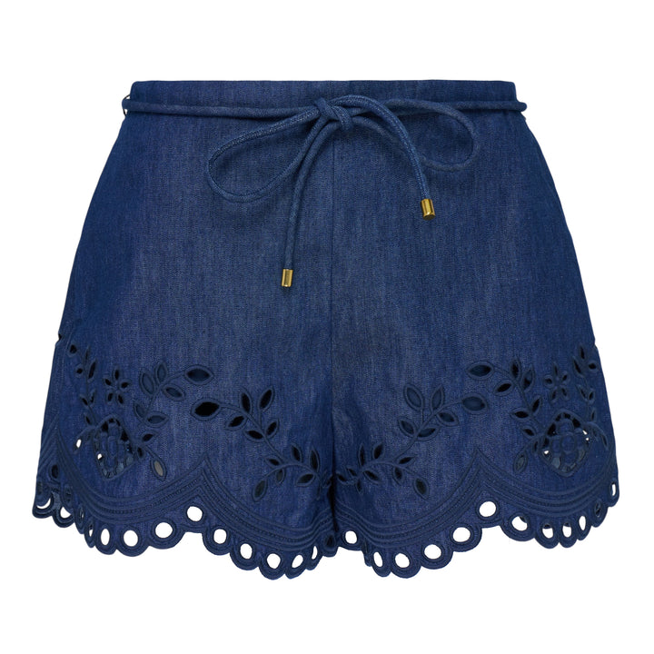 Zimmermann Mahon Broderie Denim Short in mid-wash indigo with floral eyelet embroidery, scalloped hem, and gold-tipped drawstring waist