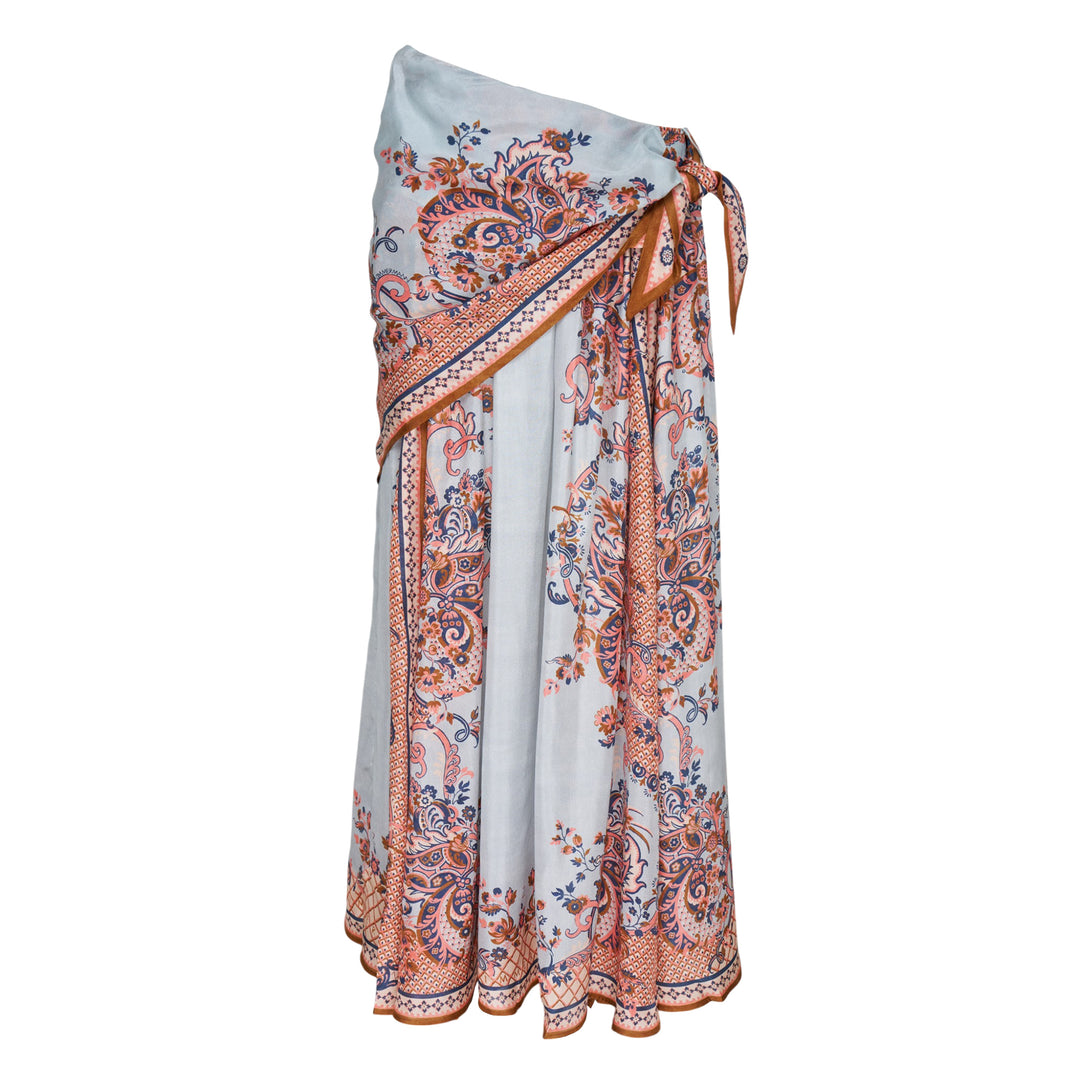 Zimmermann Aster Scarf Midi Skirt in a paisley floral print with coral, navy, and amber tones on a soft blue ground, styled with a draped overlay and side-tie waist