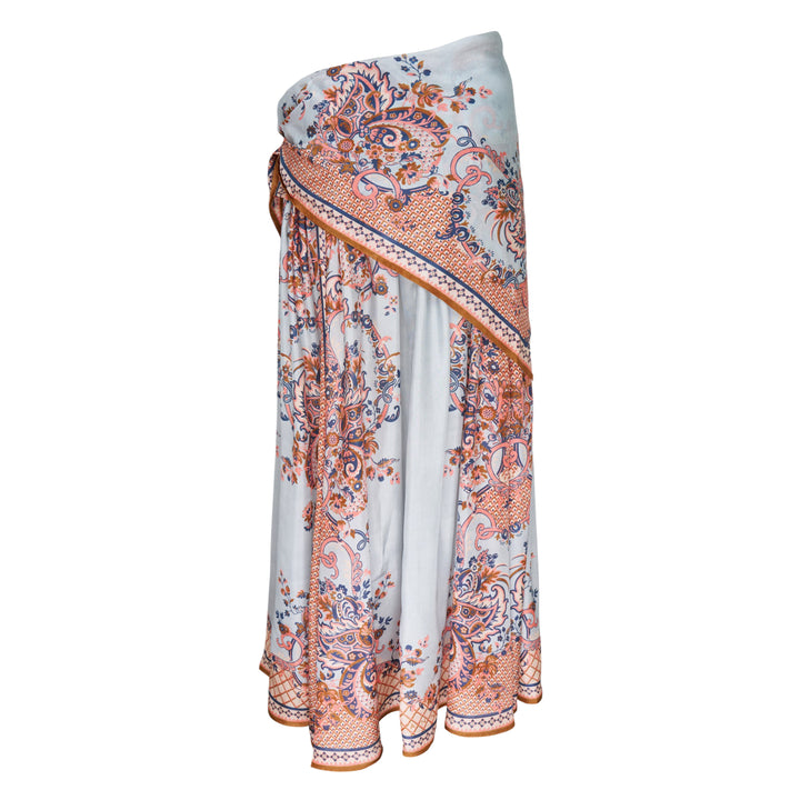 Zimmermann Aster Scarf Midi Skirt in a paisley floral print with coral, navy, and amber tones on a soft blue ground, styled with a draped overlay and side-tie waist