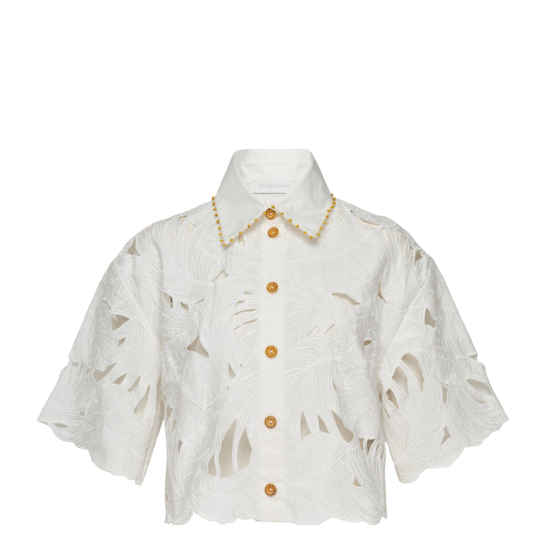 Zimmermann Mahon Embroidered Crop Shirt in ivory white with tropical leaf cutwork embroidery, gold beaded collar trim, and amber gold buttons