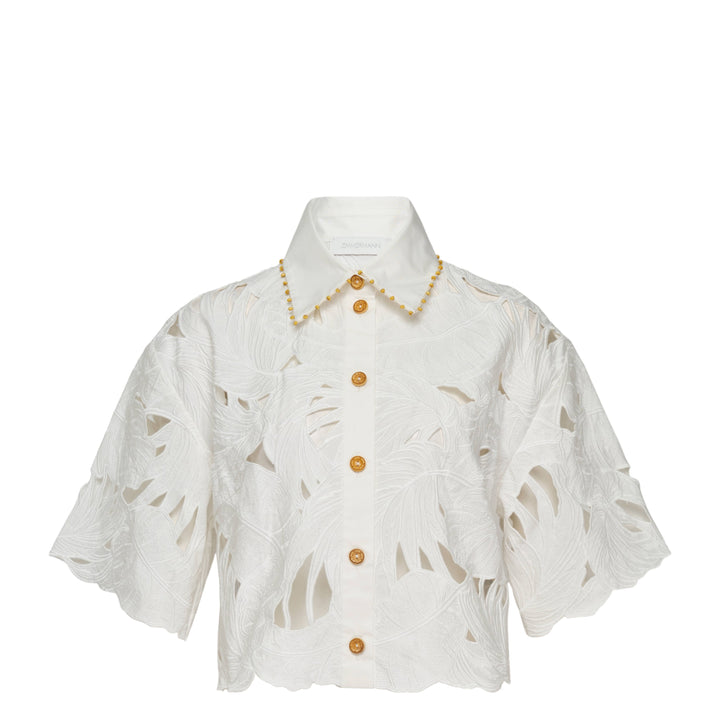 Zimmermann Mahon Embroidered Crop Shirt in ivory white with tropical leaf cutwork embroidery, gold beaded collar trim, and amber gold buttons