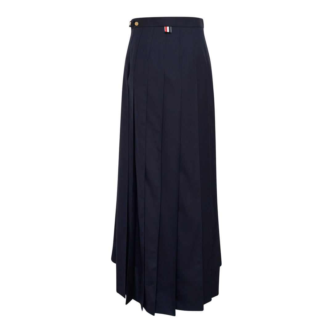 Thom Browne navy trouser-length knife-pleated skirt with high waist and signature red, white, and blue stripe trim at the hem