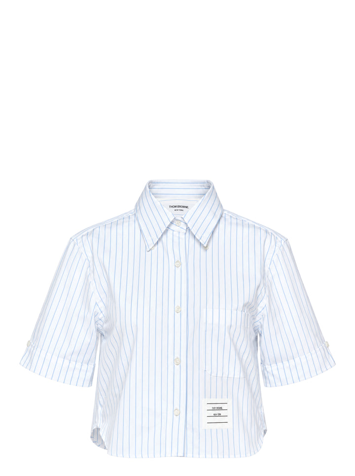Thom Browne cropped short sleeve shirt in white with blue vertical pinstripes, button-down collar, chest pocket and woven logo label at the hem