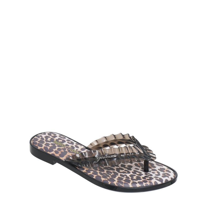 Ganni x Melissa ruffle flip flops with smoky translucent jelly ruffled thong strap, leopard-print footbed, and flat black outsole