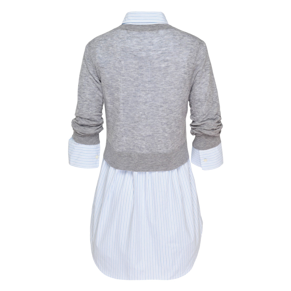 Alexander Wang hybrid mini shirt dress featuring a semi-sheer grey crewneck sweater over a blue and white striped poplin button-up, with collar, placket, and cuffs visible beneath the knit layer