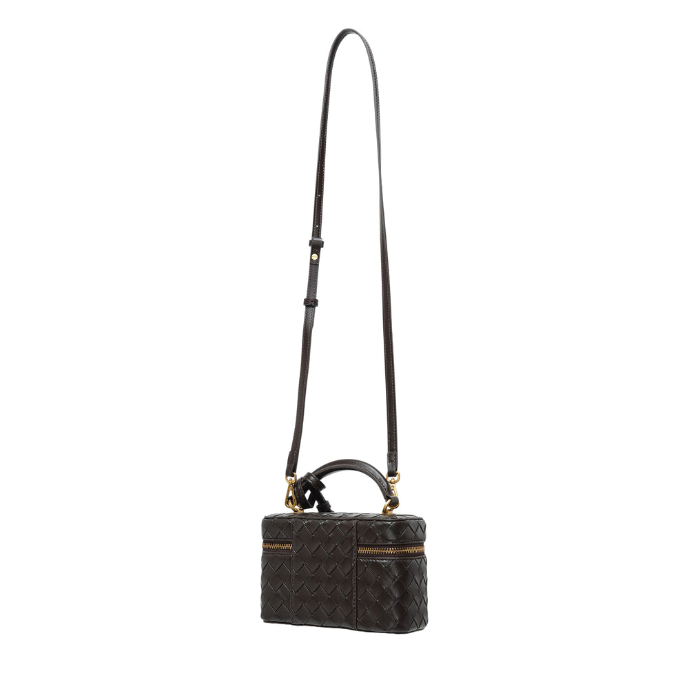 JW PEI Cleo Woven Texture Box Bag in black with intrecciato-style weave, gold-tone zip and padlock hardware, top handle, and long adjustable crossbody strap