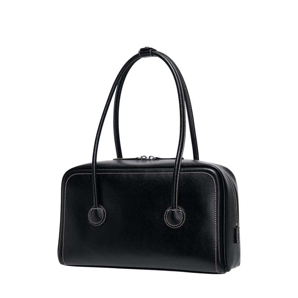 Marge Sherwood Soft Boston Small bag in black leather with contrast white stitching, dual top handles, circular grommet hardware, and embossed logo on the front panel