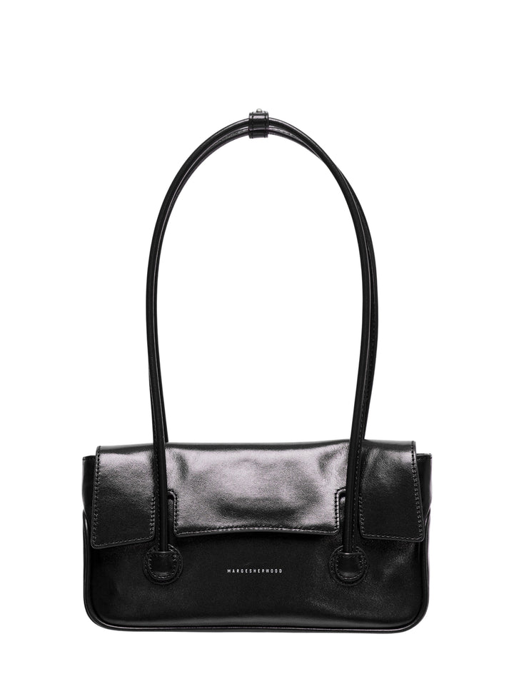 Marge Sherwood Flap Small shoulder bag in black high-shine leather with a looped top handle, front flap closure, twin side pockets, ring hardware, and contrast topstitching on a white background
