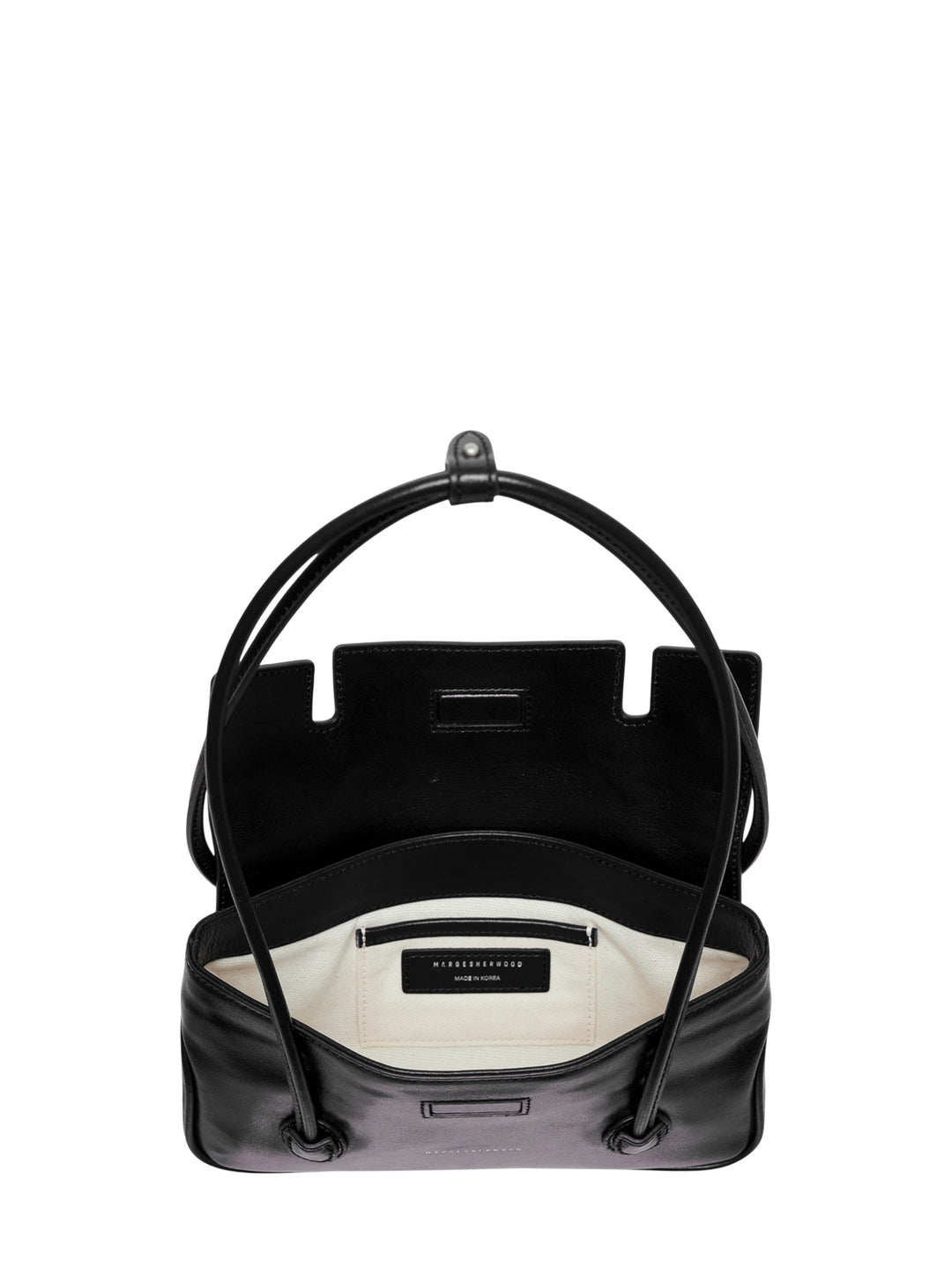 Marge Sherwood Flap Small shoulder bag in black high-shine leather with a looped top handle, front flap closure, twin side pockets, ring hardware, and contrast topstitching on a white background - view 3