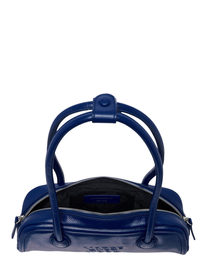 Marge Sherwood Soft Boston EW Mini shoulder bag in navy blue leather with dual top handles, zip closure, and embossed logo on a white background - view 3
