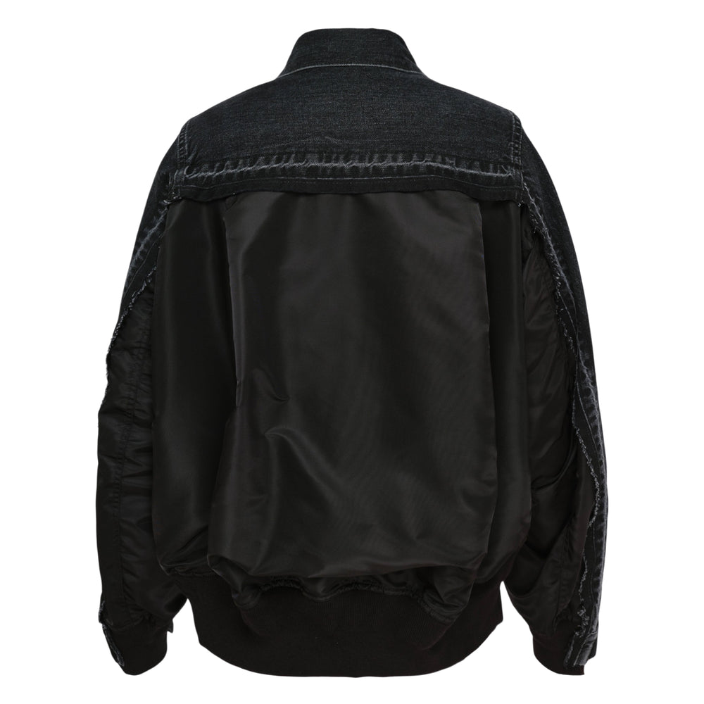 sacai Denim x Nylon Twill Jacket in washed black, front view, featuring nylon twill sleeve panels, snap-button placket, twin chest pockets, and a utility zip pocket on one sleeve
