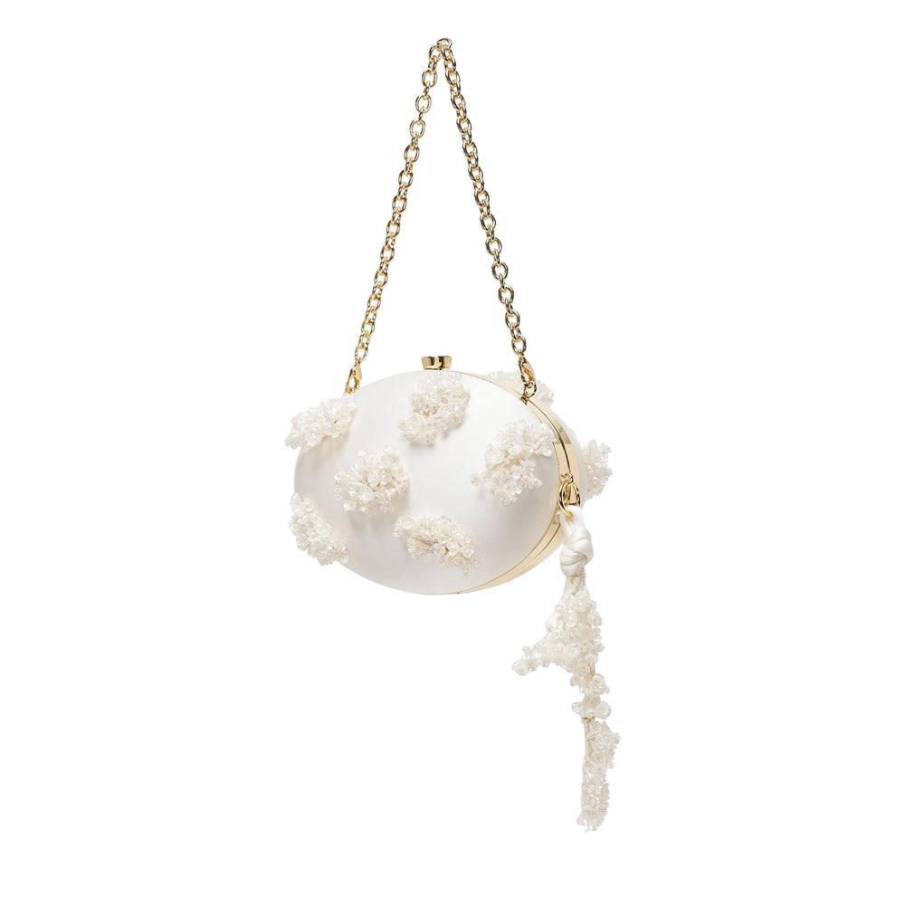 Self-Portrait cream satin oval clutch bag with three-dimensional floral bead embellishments, gold-tone chain strap, and knotted tassel charm