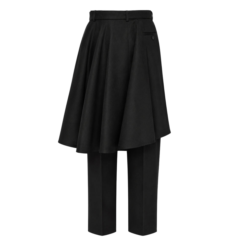 sacai Double-Faced Silk Cotton Pants in black, featuring a voluminous pleated skirt overlay over cropped straight-leg trousers, with a structured high waistband and silver-tone belt buckle