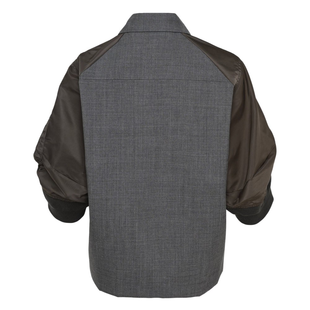 sacai Suiting x Nylon Twill Shirt Jacket in brown, featuring a wool-blend suiting body, nylon bomber-style sleeves with a zip utility pocket, ribbed cuffs, dual flap chest pockets, and a button-front closure