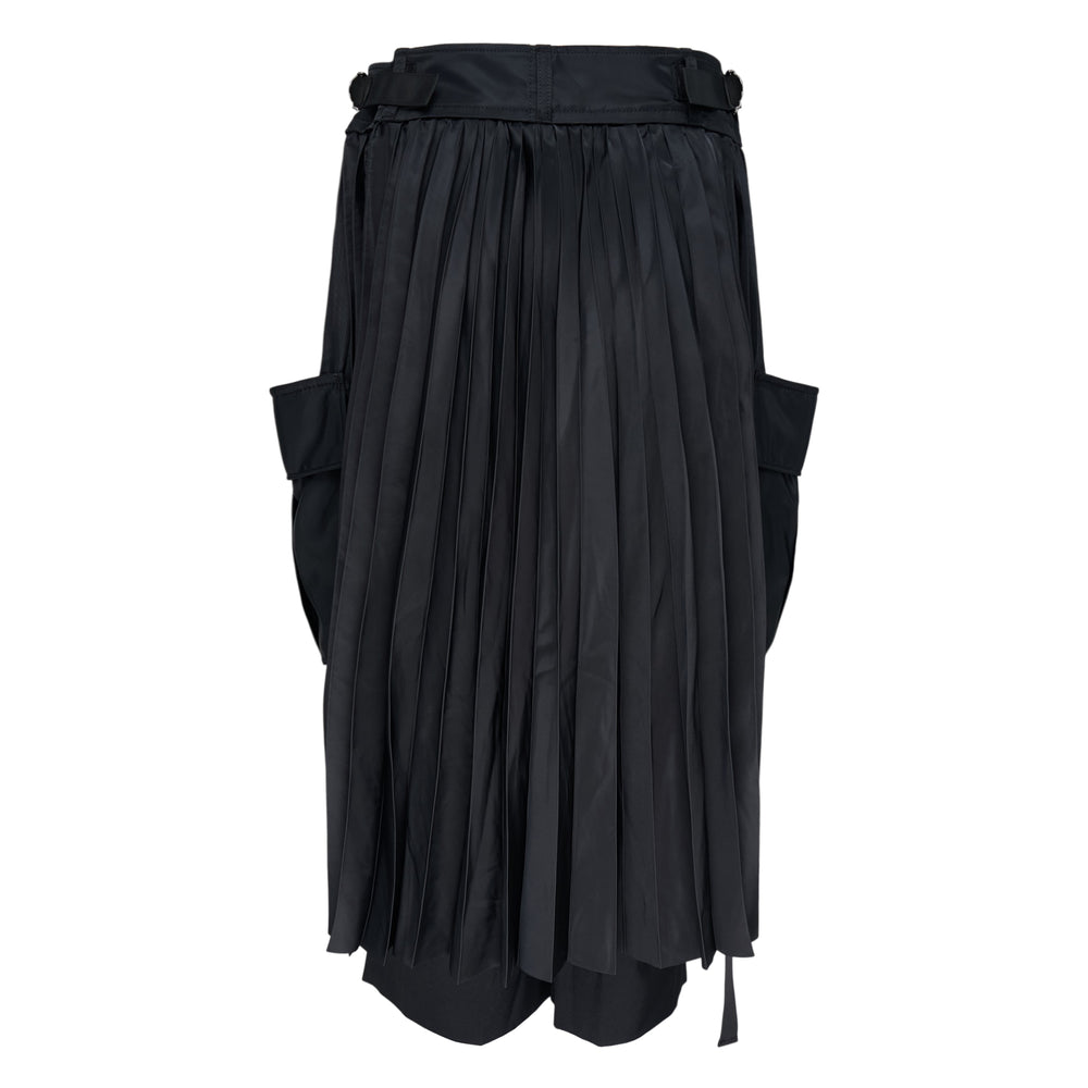 sacai Suiting x Nylon Twill Pants in black, featuring vertical satin ribbon strips, oversized cargo patch pockets, and a wide-leg silhouette with a layered nylon hem