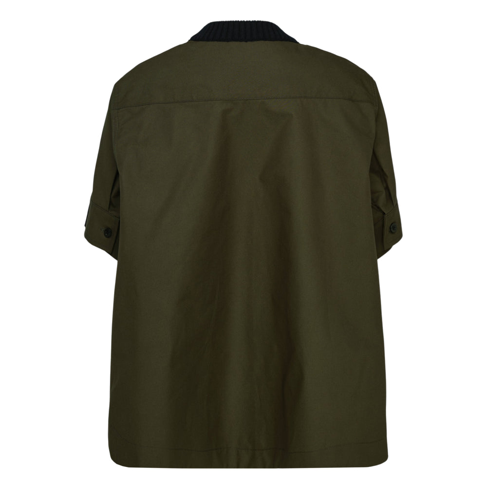 sacai hybrid short sleeve knit top in black with olive woven shirting underlayer, featuring ribbed crew neck, cuffs, and hem