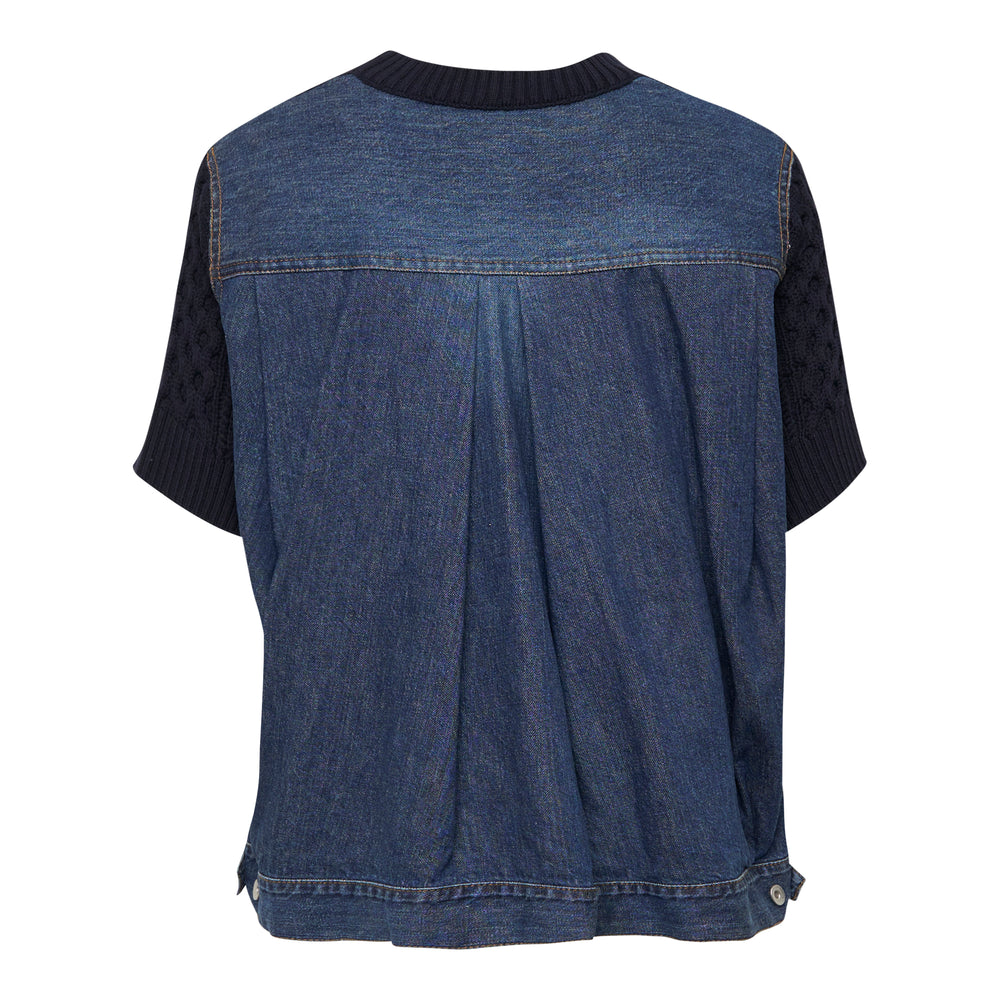 sacai Denim x Cotton Knit Pullover in black, showing cable and bobble stitch front panel with washed denim back and side panels, ribbed crew neck, and short sleeves