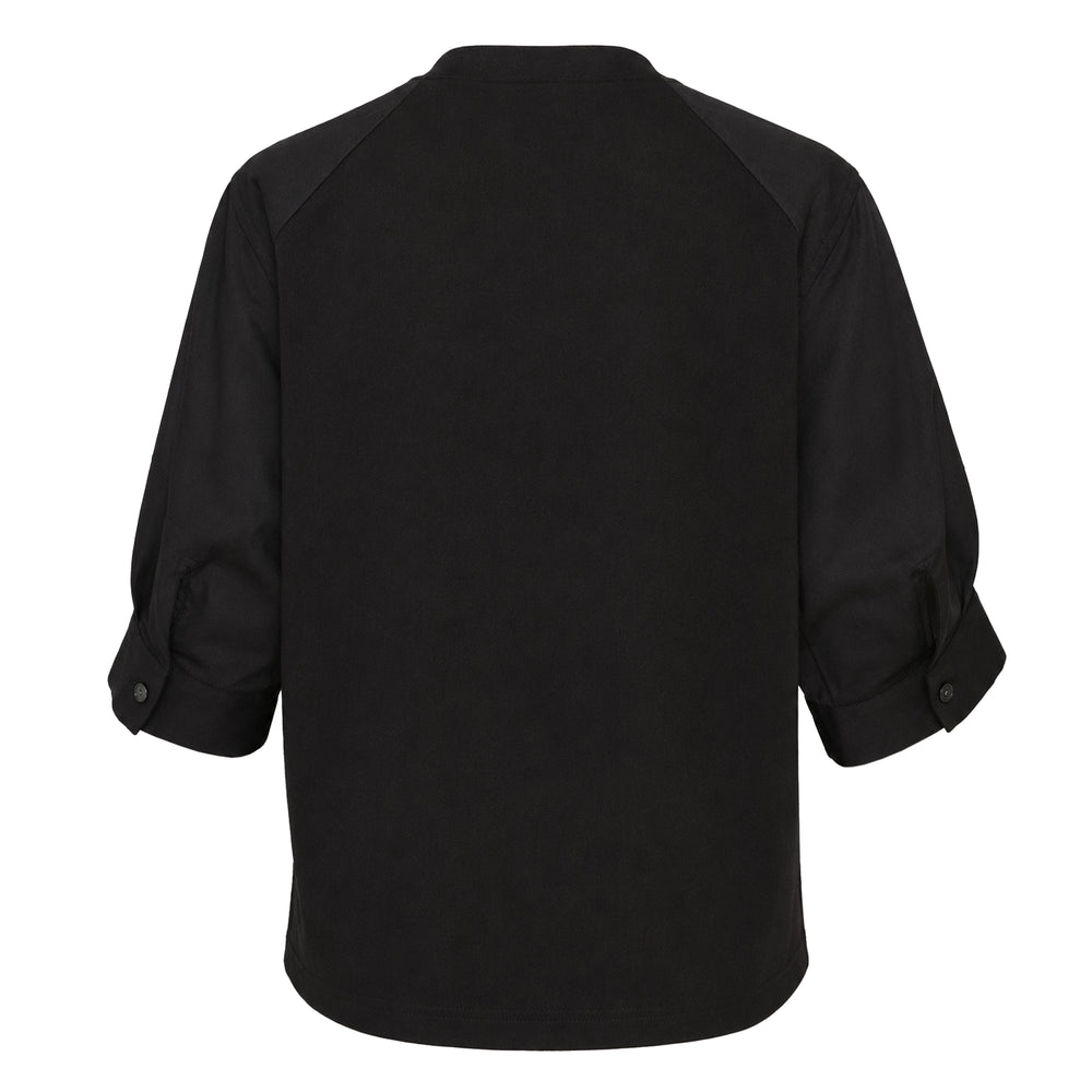 sacai Poplin Cotton Jersey Tee in black, featuring a mock neck collar, raglan sleeves, and a tonal patch chest pocket, displayed flat on a white background