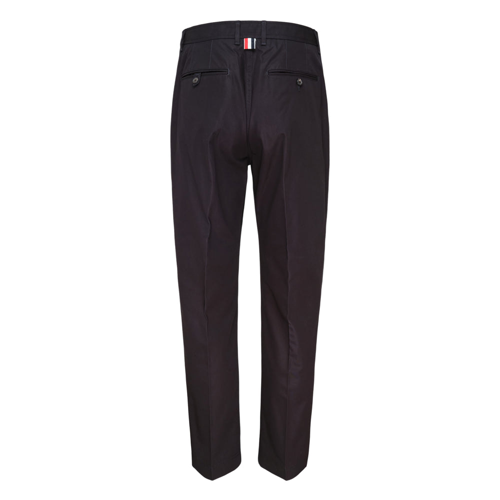 Thom Browne tapered wrinkle-resistant chinos in dark navy, displayed flat with a high-rise waistband, tapered leg, and cropped hem - view 2
