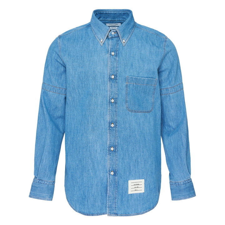 Thom Browne Straight Fit Long Sleeve Denim Shirt in medium blue wash with button-down collar, chest patch pocket, and woven brand label at hem