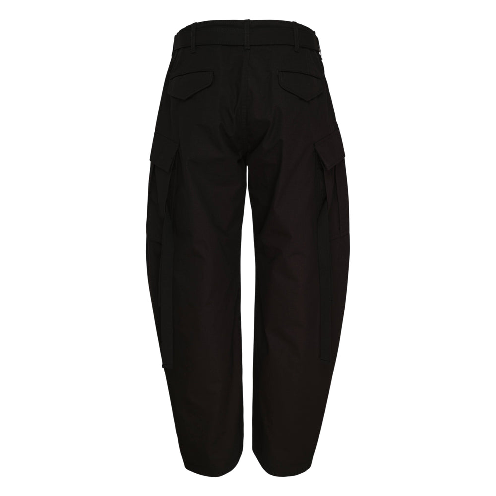 sacai Rip Stop Cargo Pants in black, featuring a high-rise buckle belt, sculptural barrel-leg silhouette, and patch cargo pockets on both legs
