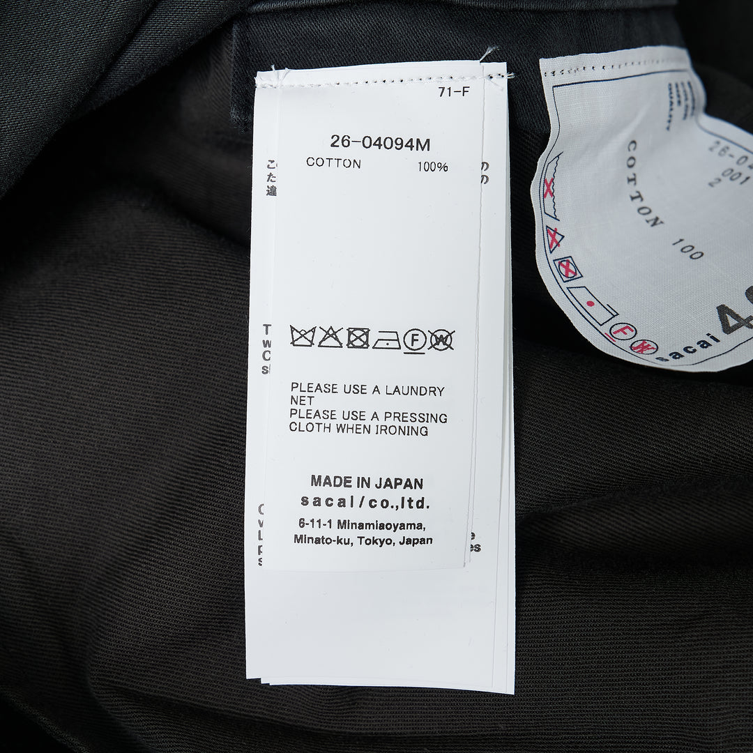 sacai Sueded Cotton Cargo Pants in washed black, featuring a balloon-leg silhouette, belted high waist, flap cargo pockets, and adjustable drawstring hems, photographed flat on a white background - view 3