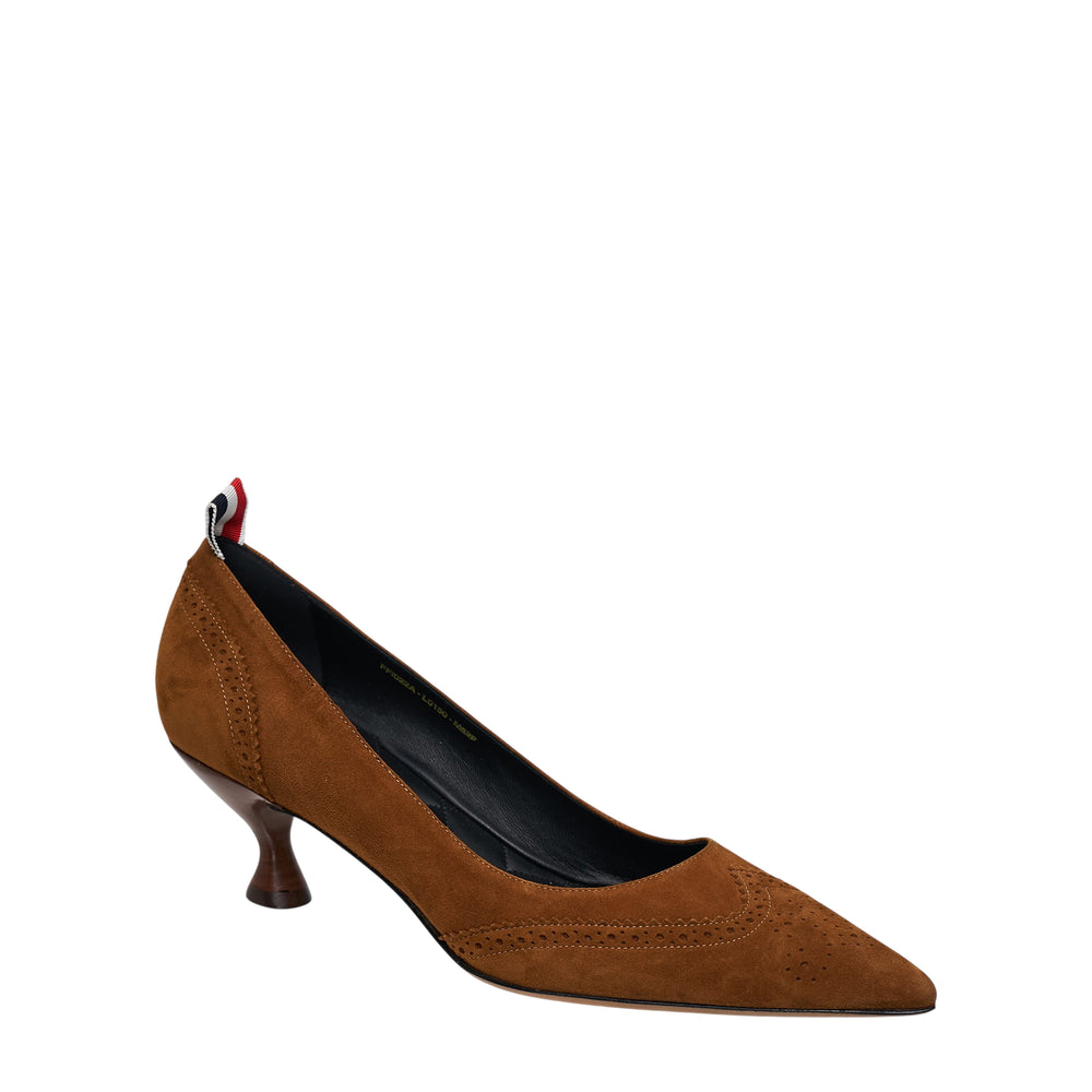 Thom Browne tan suede wingtip pump with perforated brogue detailing, pointed toe, sculptural 50mm round kitten heel, and signature grosgrain pull tab at heel collar