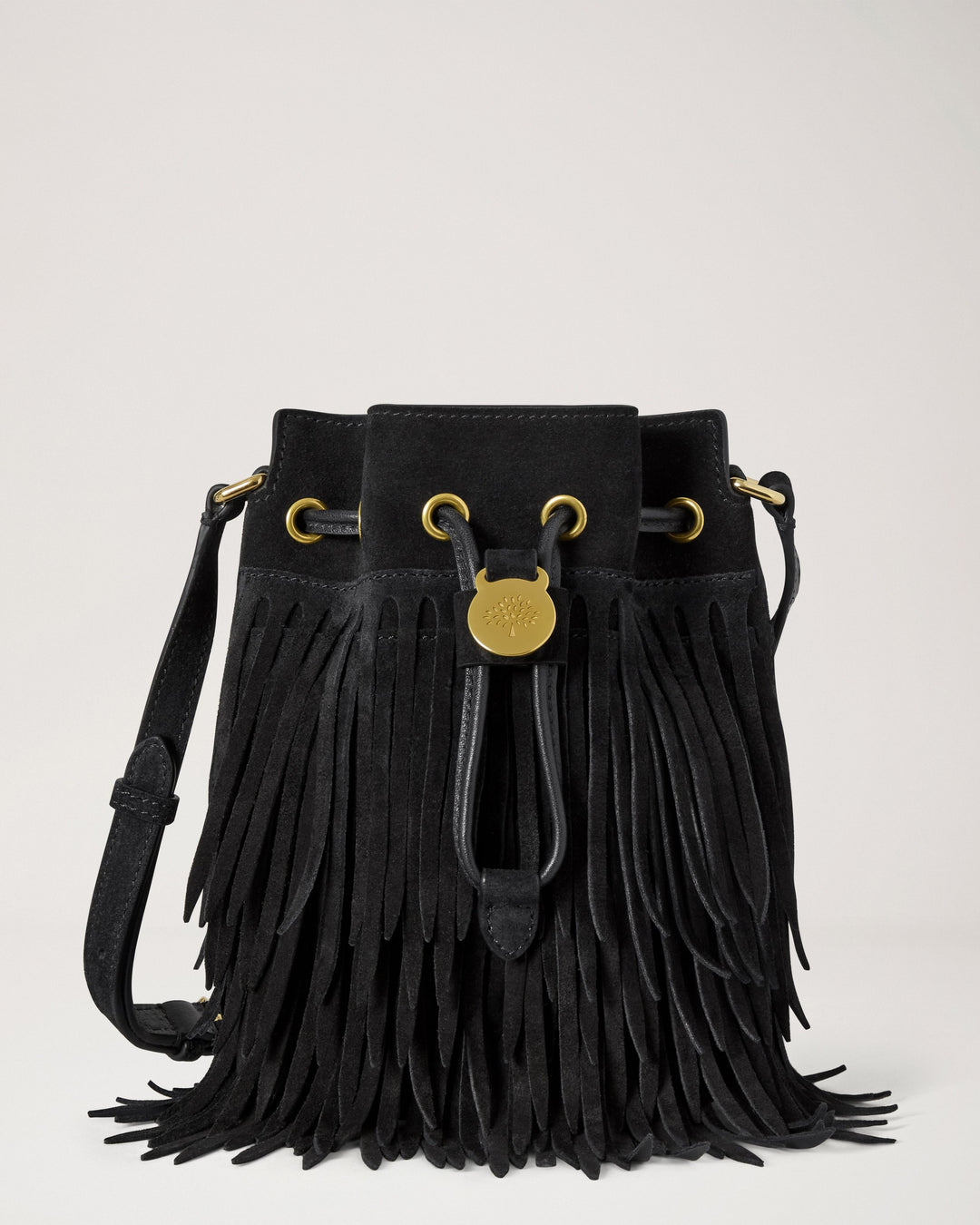 Mulberry mini black suede bucket bag with tiered fringe, gold-tone eyelets, drawstring closure with tree emblem toggle and adjustable crossbody strap