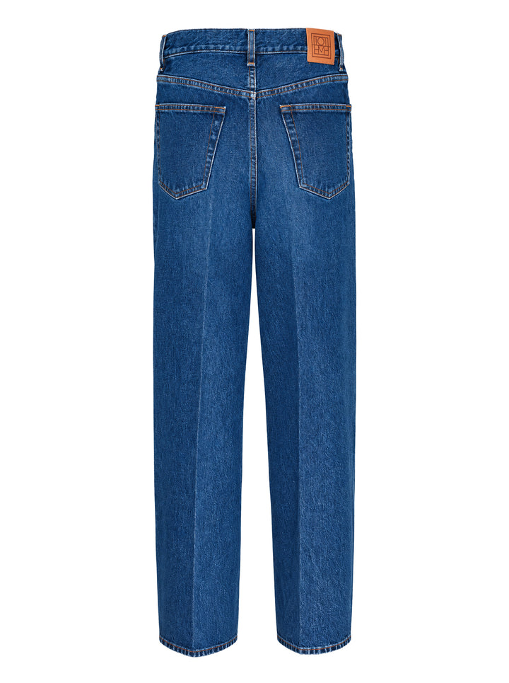Toteme Wide Leg Jeans in mid-wash blue denim with a high-rise waist, contrast orange stitching, and a relaxed wide leg silhouette - view 2