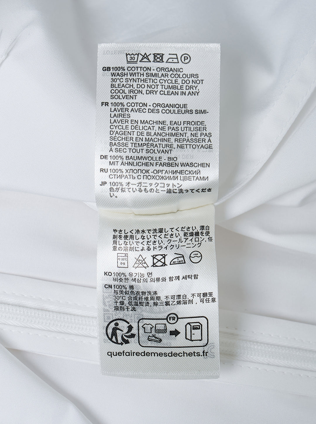 Toteme Sculptural Cotton Top in white, featuring a fitted seamed bodice, round neckline, and short fluted sleeves with a folded hem detail, shown from the front against a white background - view 3