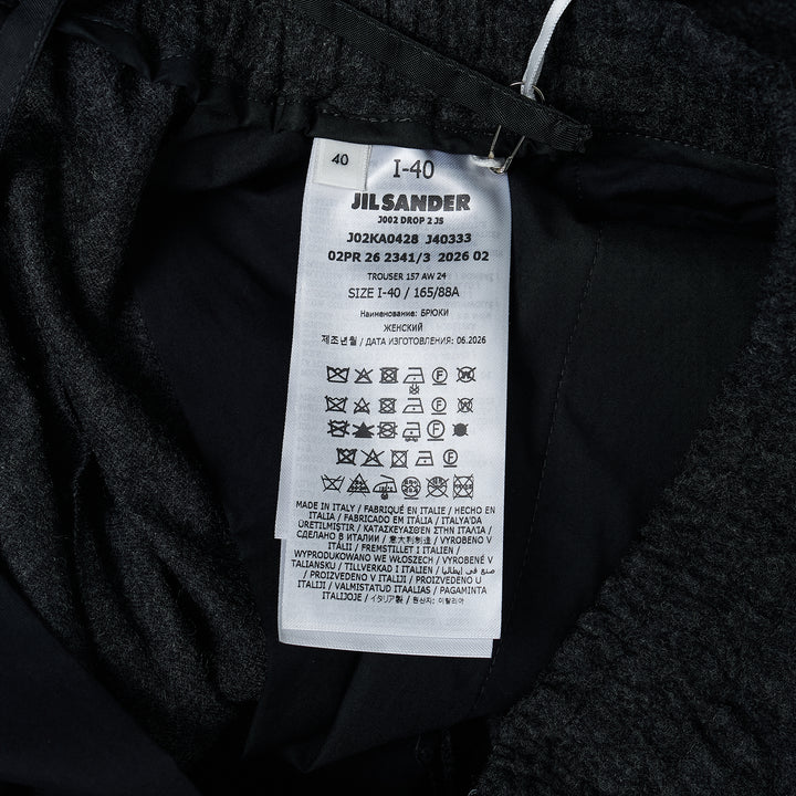 Jil Sander Light Merino wide-leg trousers in dark charcoal with elasticated waistband and clean straight-leg silhouette, front view