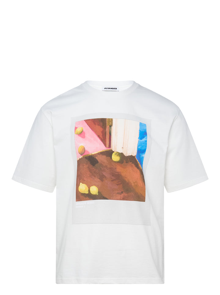 Jil Sander white oversized short sleeve crew neck T-shirt with a painterly still-life print featuring lemons on a terracotta, pink, and blue painted background