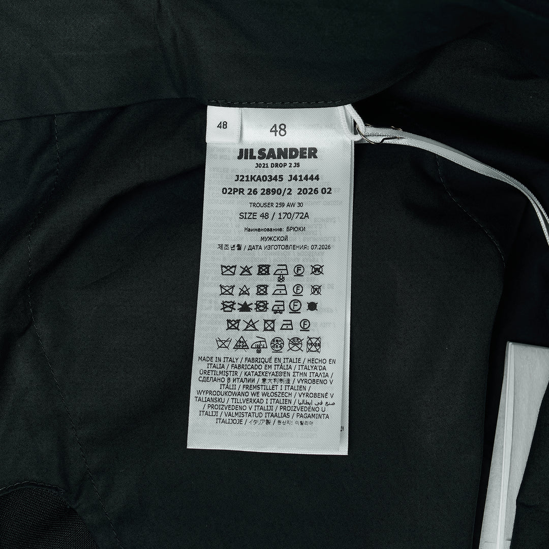Jil Sander black wool mohair wide-leg trousers with front crease and adjustable back waistband buckle, flat-front view