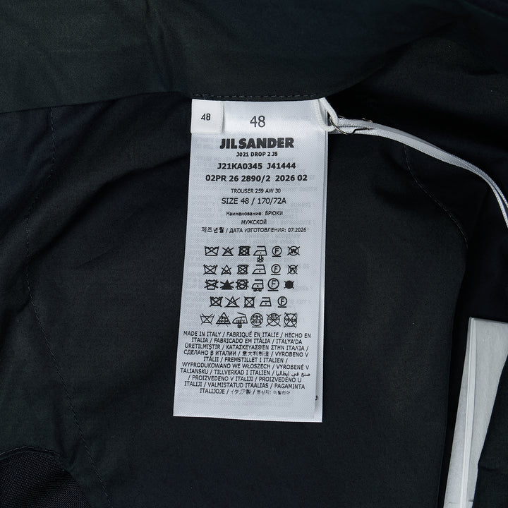 Jil Sander black wool mohair wide-leg trousers with front crease and adjustable back waistband buckle, flat-front view