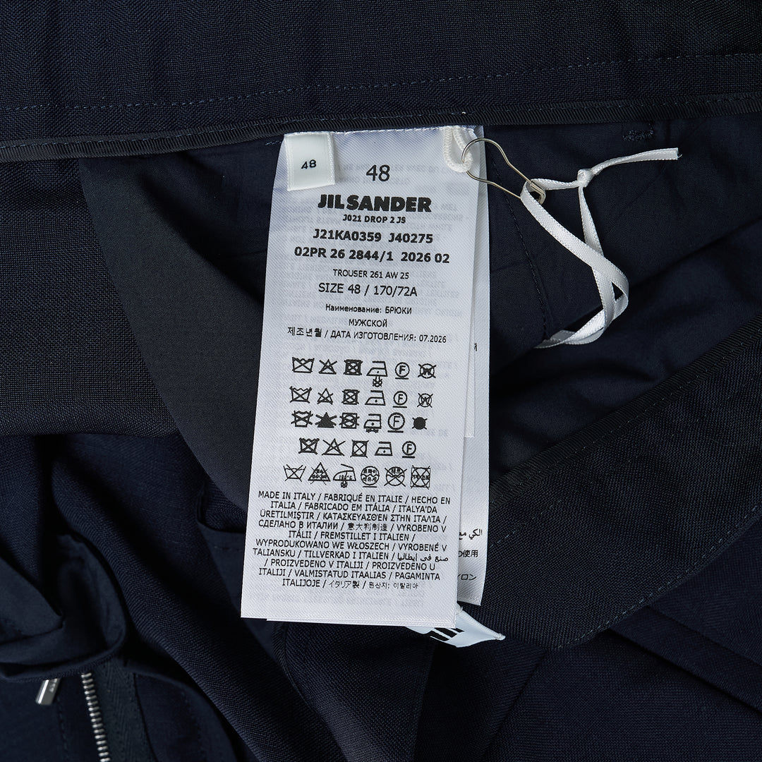 Jil Sander navy fil-a-fil wool wide-leg trousers with high-rise waist, single forward pleat, and sharp pressed front crease, displayed flat on a white background