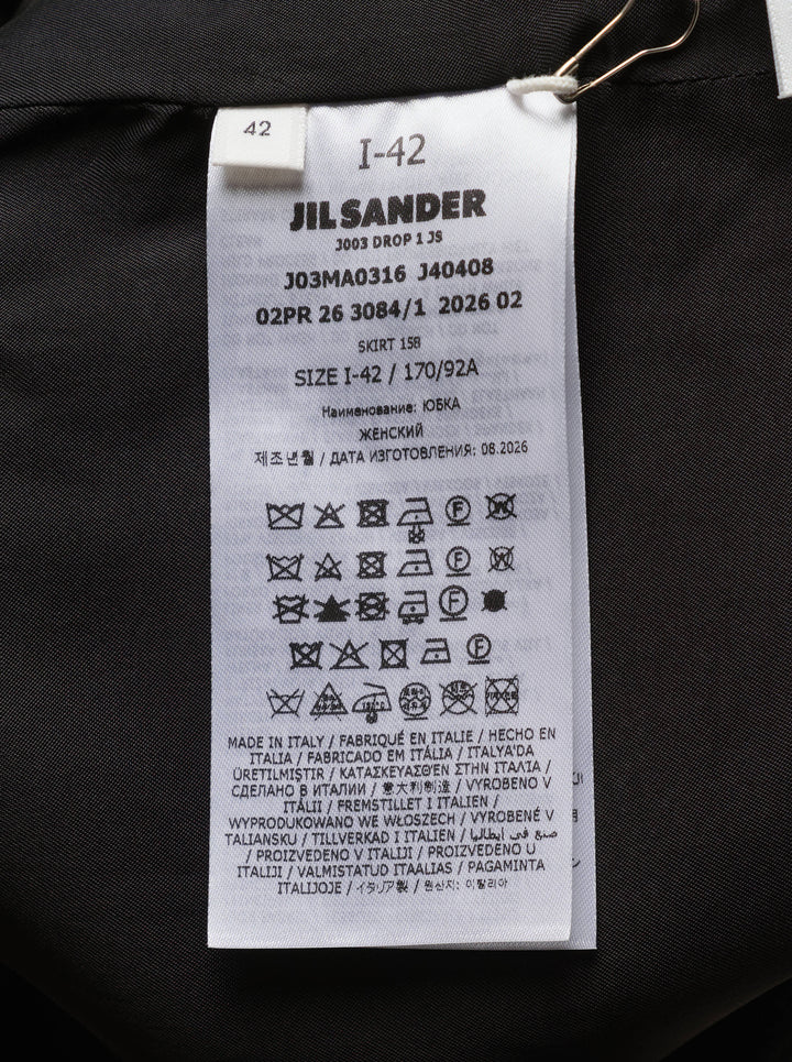 Jil Sander heavy textured sablé black midi skirt with dramatic asymmetric cut-out hem and high-rise waistband, displayed on white background - view 3