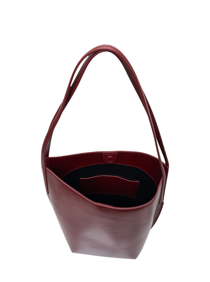 Jil Sander Kante Tote in deep burgundy shiny lambskin leather with a slim shoulder strap and open-top structured silhouette, front view - view 3