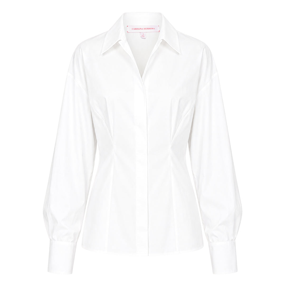 Carolina Herrera white fitted waist long sleeve collared shirt with bishop sleeves, cinched waist seaming, and concealed button front placket, displayed on a flat lay against a white background