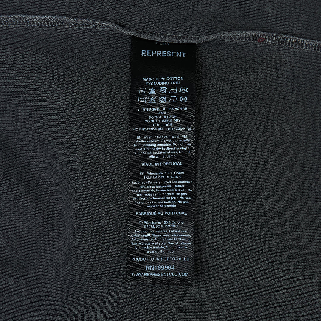 Represent Owners Club T-Shirt in washed black, rear view showing bold back graphic print with 'Represent Owners Club – Powered by Enthusiasts for Enthusiasts' text