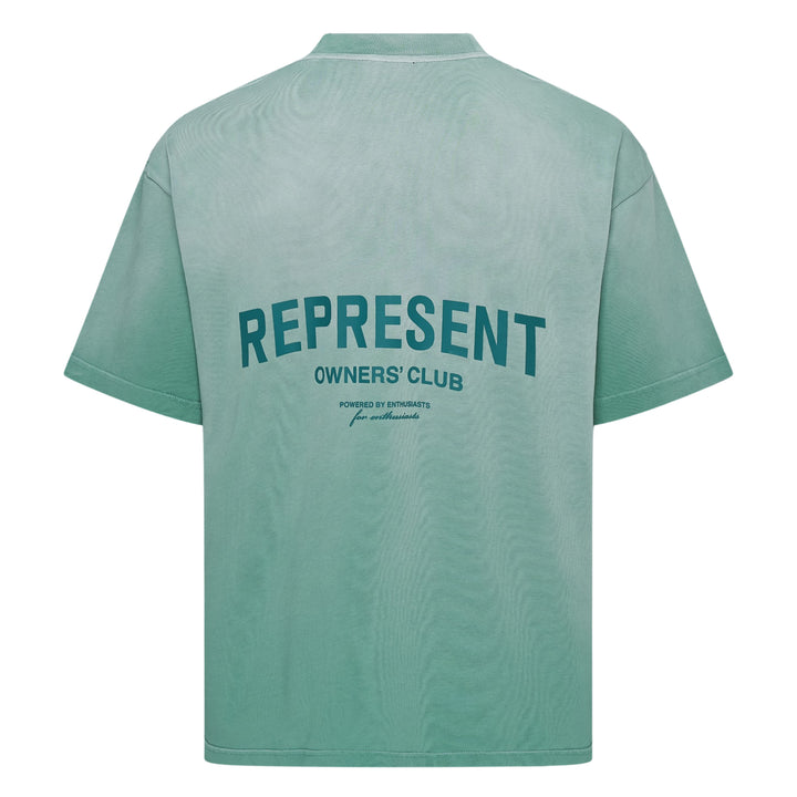Represent Owners Club T-Shirt in washed black, rear view showing bold back graphic print with 'Represent Owners Club – Powered by Enthusiasts for Enthusiasts' text