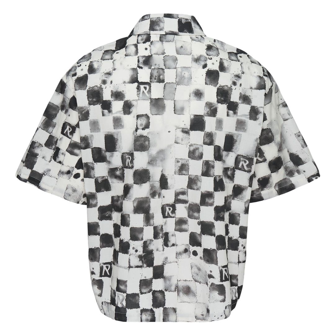 Represent Pool Side Short Sleeve Shirt in a distressed monochrome checkerboard print with repeat 'R' monogram square patches, dual chest pockets, and button-through front fastening, laid flat on a white background.